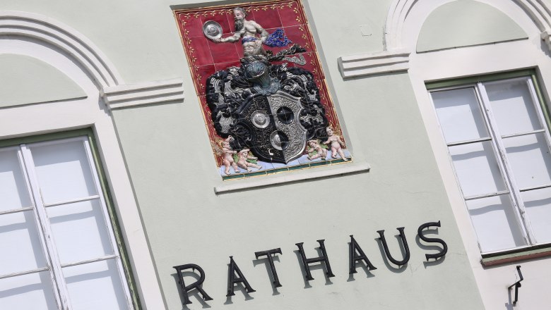 Rathaus, © schwarz-koenig.at Fassade eines Rathauses mit dekorativem Wappen und Schriftzug 'Rathaus'.