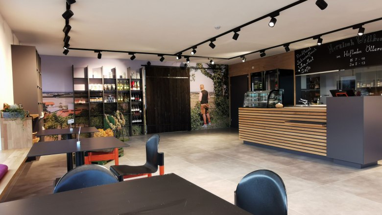 farm shop-small, © Helmut Leonhartsberger Entrance area with chairs and a wooden reception desk.