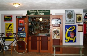 Mostviertel Farmers' Museum, © Familie Distelberger Historic store in the Mostviertel Farmers' Museum with old advertising signs and a bicycle.