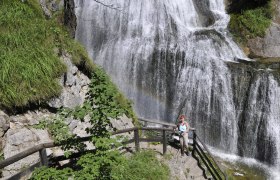 Palfau waterhole gorge, © fotosoos.at A woman stands on a staircase in front of a waterfall in the Palfau waterhole gorge.