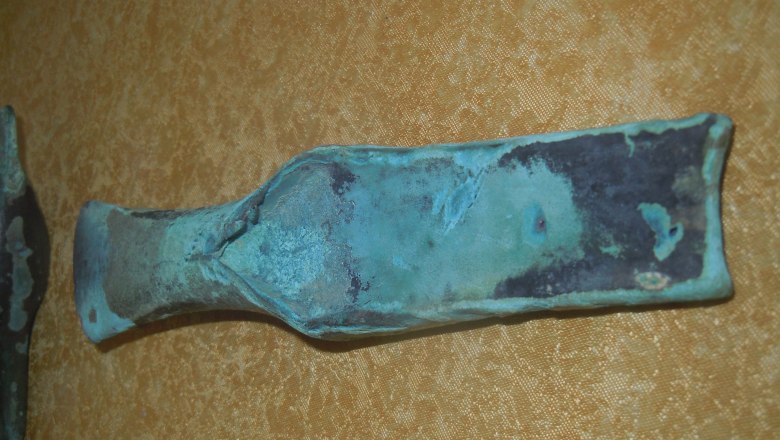 Heimatkundliche Exponate, © Heimatmuseum Hofstetten-Grünau Ein altes, oxidiertes Metallwerkzeug auf gelbem Hintergrund.