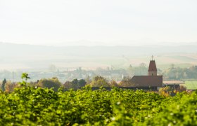 Landschaft mit Kirche und Feldern in Perschling.