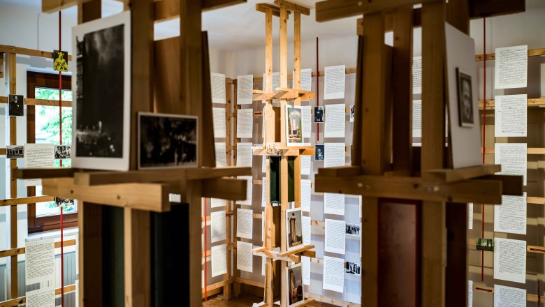 Interior view of the Erlauf Peace Museum with wooden installation and documents on display.