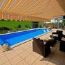 Terrace with pool and awning at vacation home Eva Deufl.