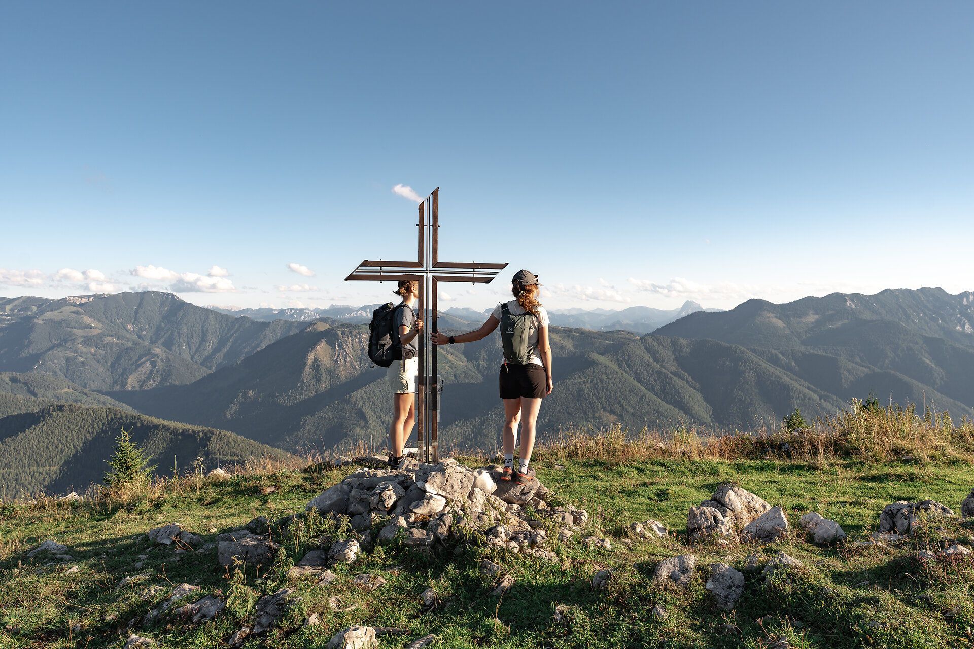 Auf dem Gipfel des Königsbergs, umgeben von majestätischen Ybbstaler Alpen, genießen Wanderer den atemberaubenden Ausblick auf die sanften Hügel und tiefen Täler. Die frische Bergluft und das sanfte Licht der Abendsonne schaffen eine unvergessliche Atmosphäre der Ruhe und Erholung.