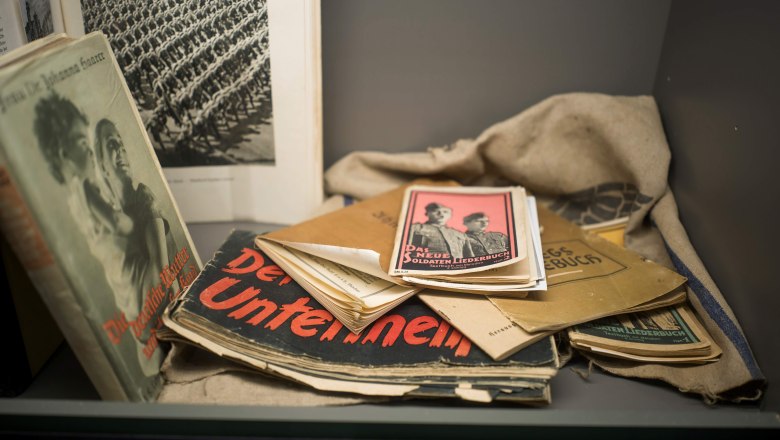 Historical books and documents in a display case in the Erlauf Peace Museum.