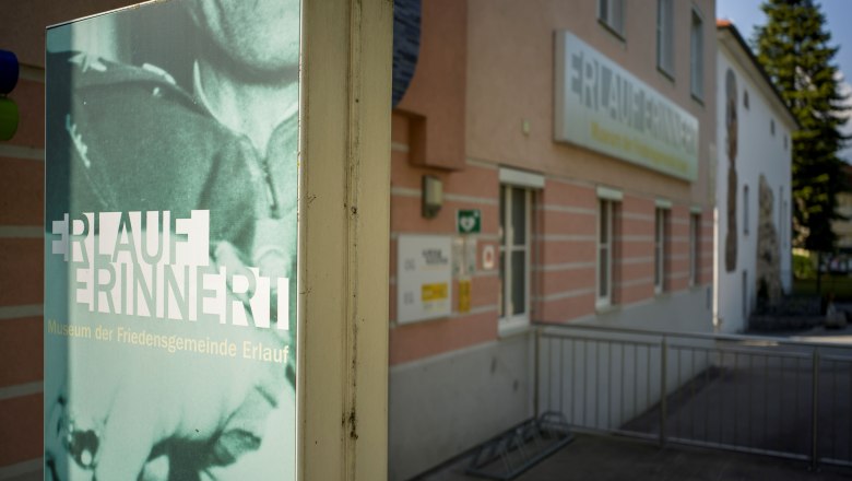 Exterior view of the Erlauf Peace Museum with sign 'Erlauf remembers'.