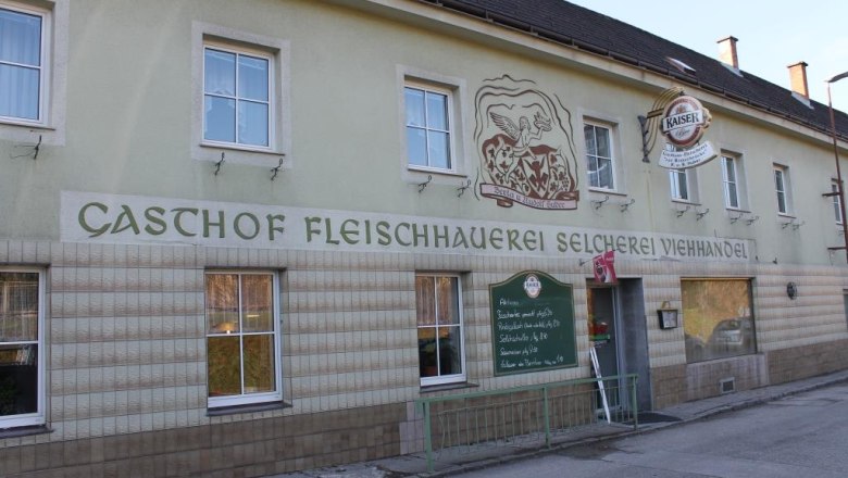 Au&szlig;enansicht eines Gasthofs mit der Aufschrift 'Gasthof Fleischhauerei Selcherei Viehhandel'.