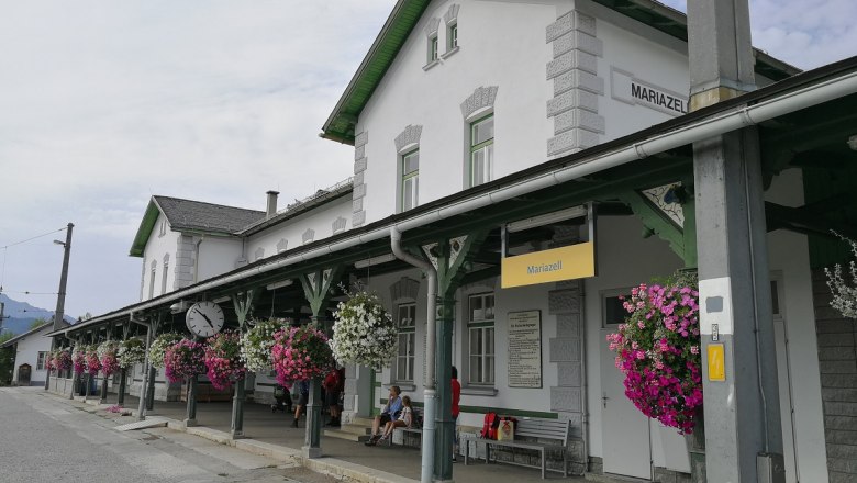 Mariazell station with flowers and clock.
