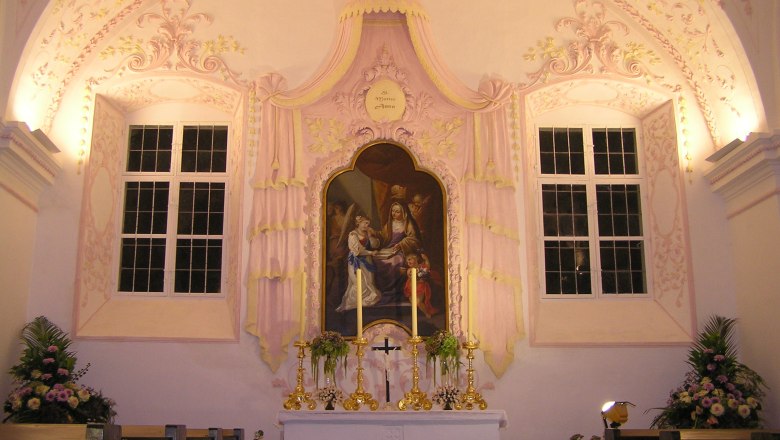 Interior view of a chapel with altar and religious painting.